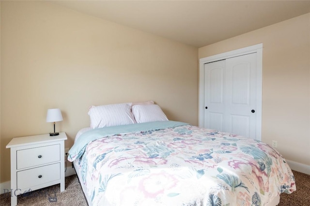 bedroom with carpet, a closet, and baseboards