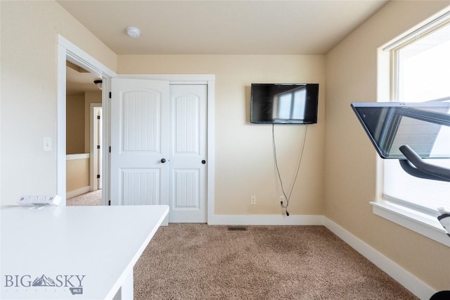 unfurnished office with carpet floors and baseboards