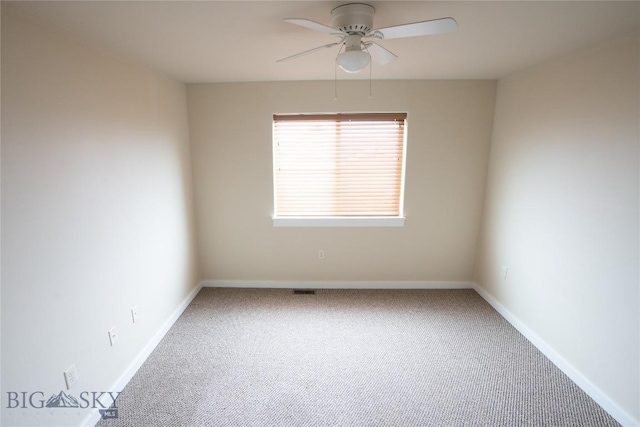 carpeted empty room with ceiling fan and baseboards