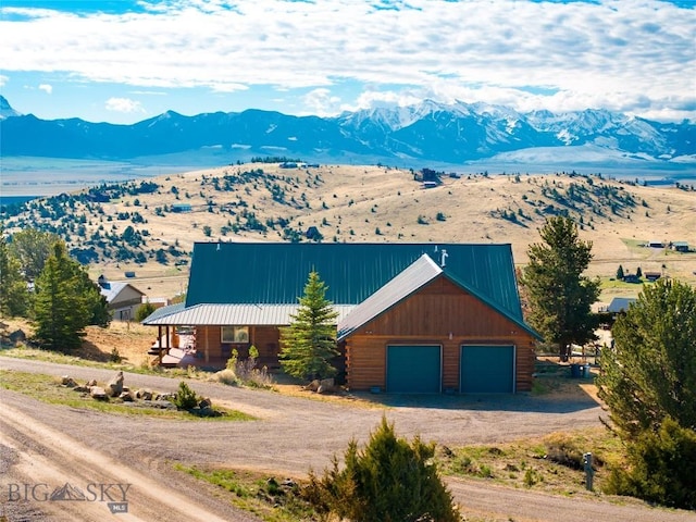 101 Deerfoot Trl, Ennis, MT 59729 - view of front facade featuring dirt driveway, a mountain view, log exterior, and metal roof