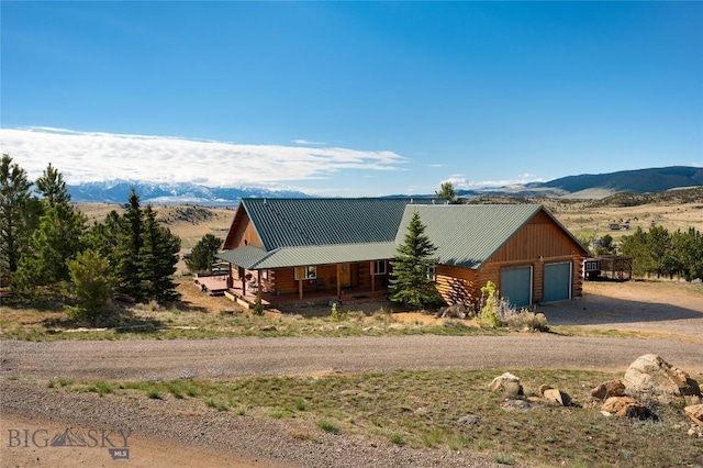 101 Deerfoot Trl, Ennis, MT 59729 - log cabin featuring a porch, dirt driveway, a mountain view, and log siding