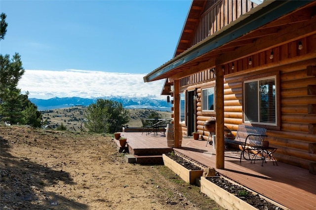 101 Deerfoot Trl, Ennis, MT 59729 - view of home's exterior with a deck with mountain view and log siding