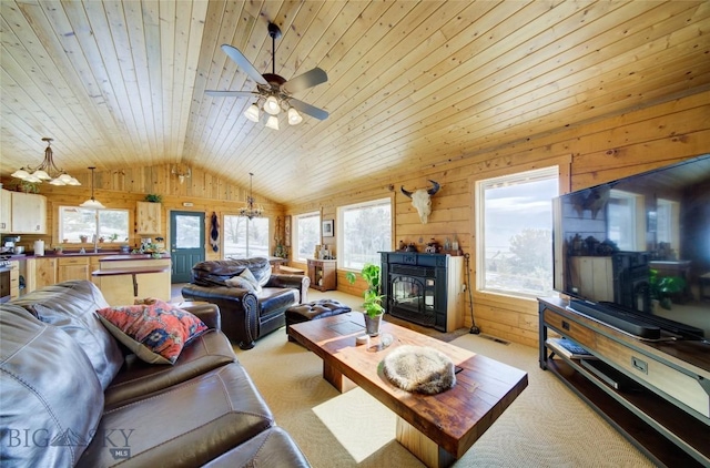 101 Deerfoot Trl, Ennis, MT 59729 - living room featuring vaulted ceiling, wood walls, light colored carpet, wooden ceiling, and healthy amount of natural light