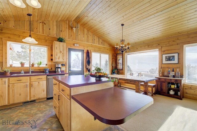 101 Deerfoot Trl, Ennis, MT 59729 - kitchen featuring stainless steel dishwasher, dark countertops, lofted ceiling, a sink, and wooden walls