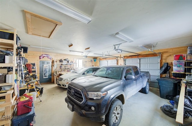 101 Deerfoot Trl, Ennis, MT 59729 - garage featuring wood walls and a garage door opener