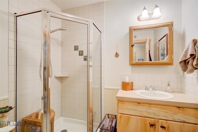 101 Deerfoot Trl, Ennis, MT 59729 - full bathroom with a stall shower, vanity, decorative backsplash, and wainscoting