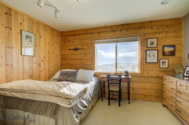 101 Deerfoot Trl, Ennis, MT 59729 - bedroom with wood walls and light carpet