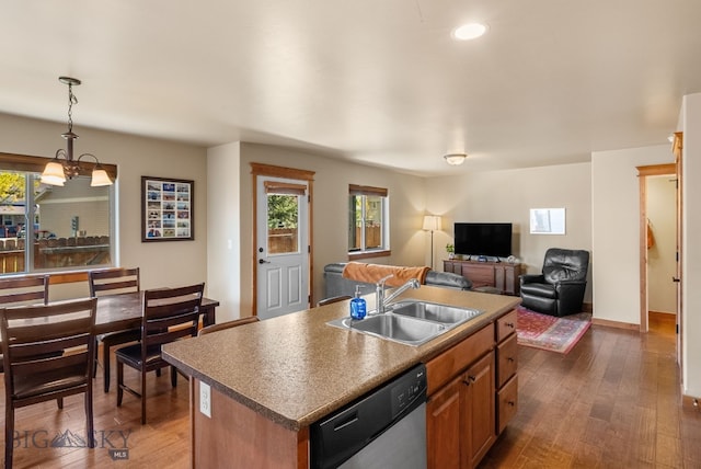 kitchen with stainless steel dishwasher, a sink, healthy amount of natural light, dark wood-style floors, and recessed lighting