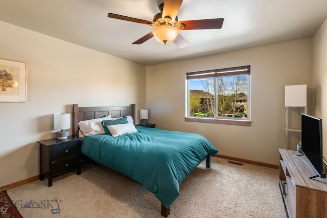 bedroom with baseboards, light carpet, and ceiling fan