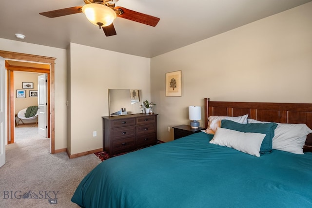 carpeted bedroom with baseboards and a ceiling fan