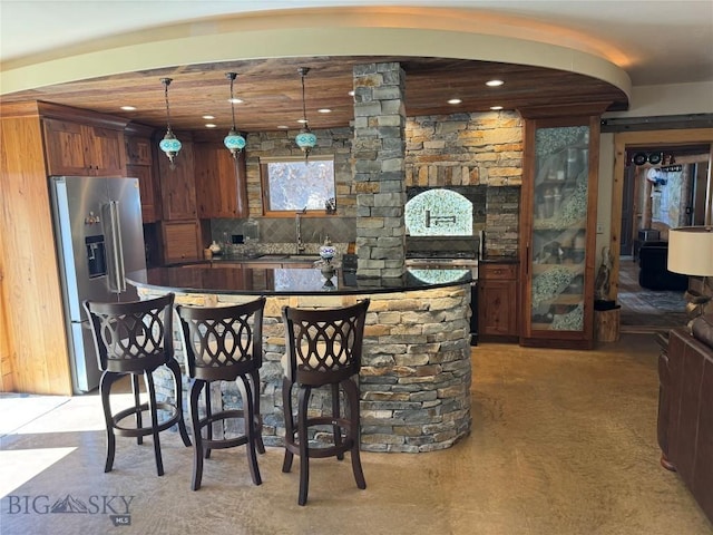 31 Basin Creek Rd, Boulder, MT 59631 - kitchen with high end refrigerator, dark countertops, a center island, recessed lighting, and pendant lighting