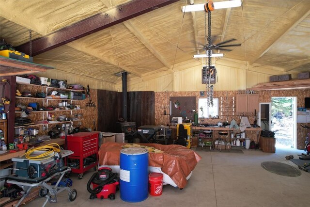 31 Basin Creek Rd, Boulder, MT 59631 - garage with a workshop area, wood walls, a wood stove, and a ceiling fan