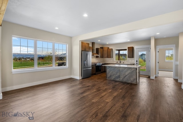 1650 Windrow, Bozeman, MT 59718 - kitchen featuring appliances with stainless steel finishes, light countertops, dark wood-type flooring, baseboards, and a center island