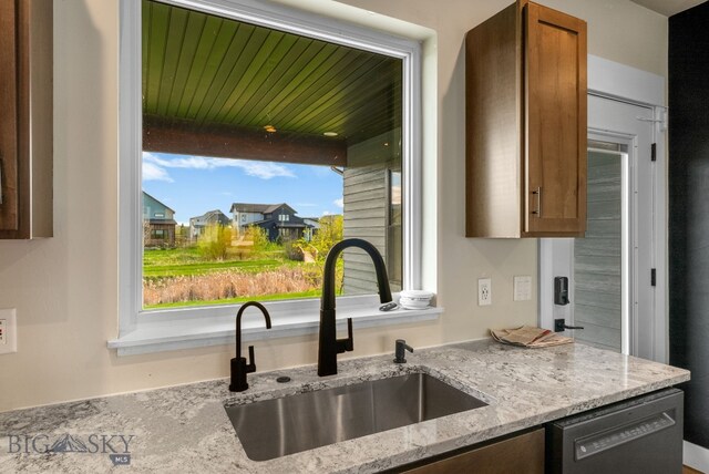 1650 Windrow, Bozeman, MT 59718 - kitchen featuring a sink, dishwasher, light stone countertops, and brown cabinets