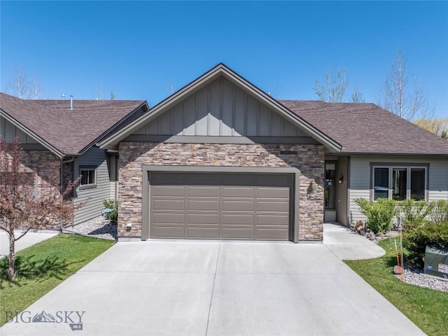view of front facade featuring board and batten siding, an attached garage, and driveway
