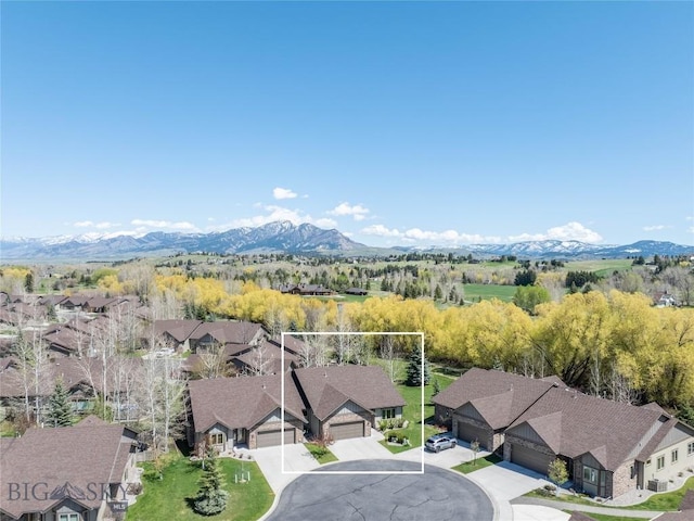aerial view of residential area featuring property boundaries highlighted and a mountainous background