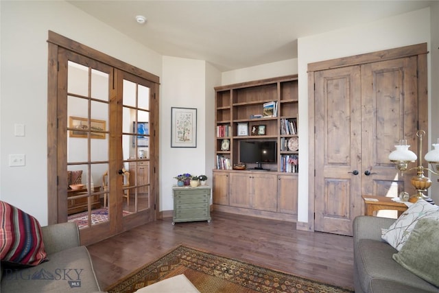 sitting room featuring french doors and dark wood-style floors