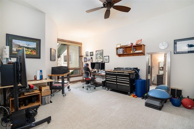 carpeted home office with a ceiling fan
