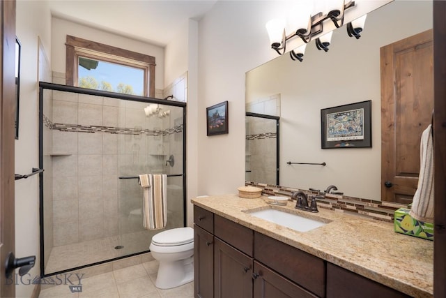 full bathroom with tiled shower, toilet, tile patterned floors, and vanity