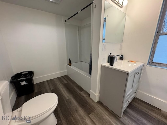 1100 Caledonia St, Butte, MT 59701 - bathroom featuring wood finished floors, bathing tub / shower combination, vanity, toilet, and baseboards