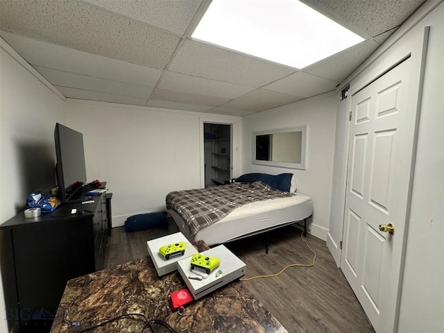 1100 Caledonia St, Butte, MT 59701 - bedroom with wood finished floors, a paneled ceiling, and baseboards
