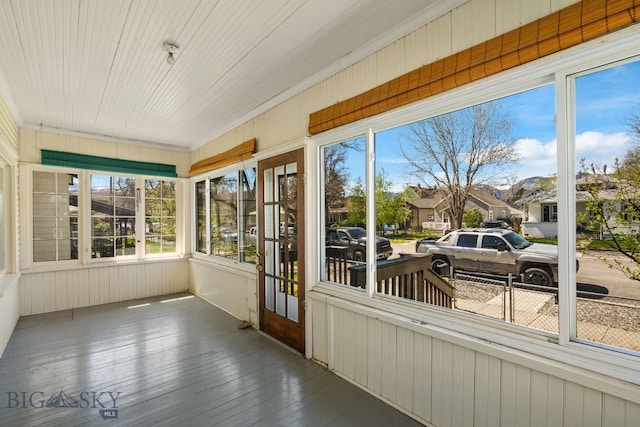 sunroom with a residential view and plenty of natural light