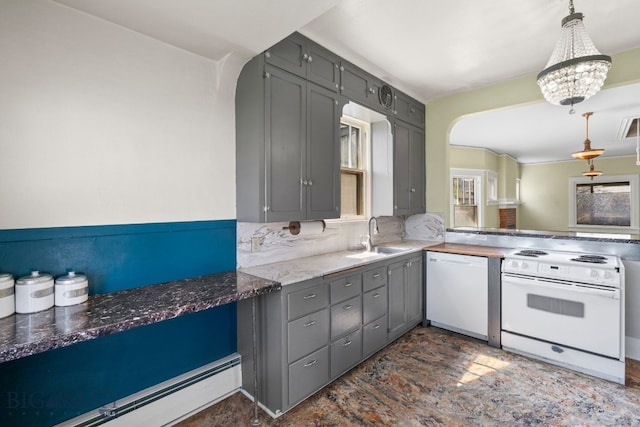 kitchen with white appliances, a sink, a baseboard radiator, and arched walkways