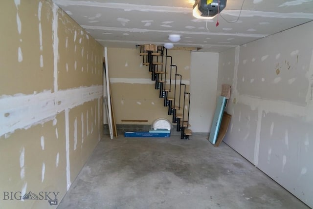 below grade area featuring a garage and stairway