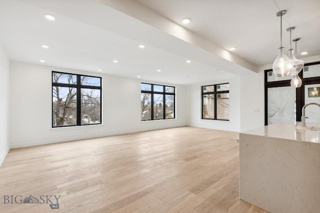 unfurnished room with recessed lighting, light wood-type flooring, and baseboards