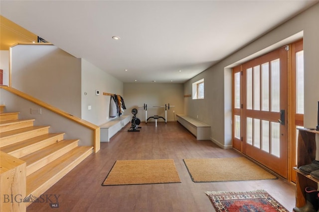 entryway with wood finished floors, stairs, recessed lighting, and baseboards