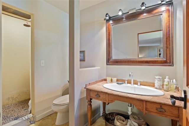 bathroom featuring a shower stall, toilet, vanity, and tile patterned floors