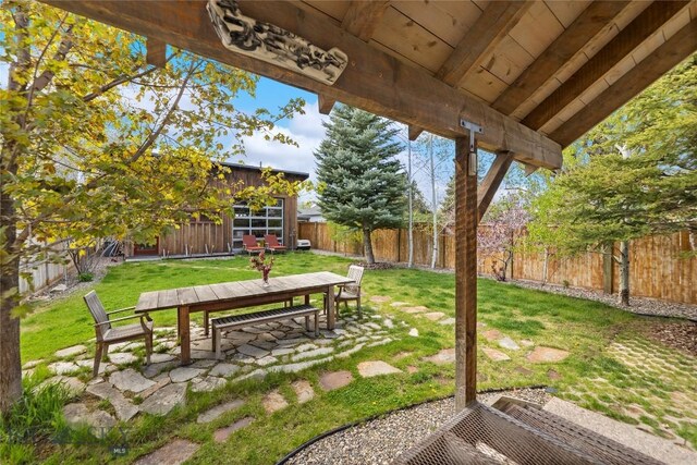 view of yard with outdoor dining space and a patio