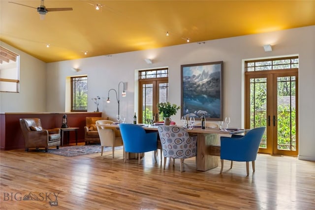 sitting room featuring french doors, wood finished floors, plenty of natural light, lofted ceiling, and ceiling fan