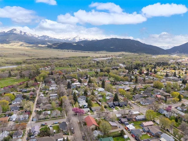 aerial view of property's location with mountains and nearby suburban area