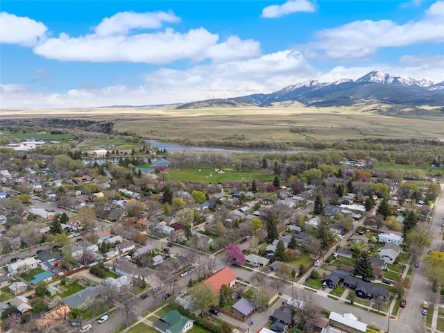 aerial view of property and surrounding area with mountains and nearby suburban area