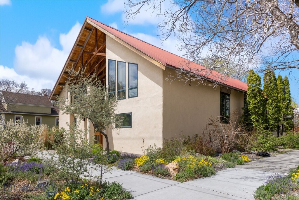 802 W Geyser St, Livingston, MT 59047 - view of home's exterior featuring stucco siding and metal roof