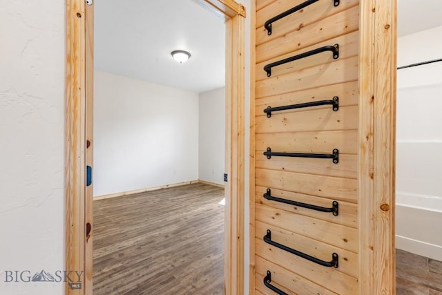 hall with wood finished floors and baseboards
