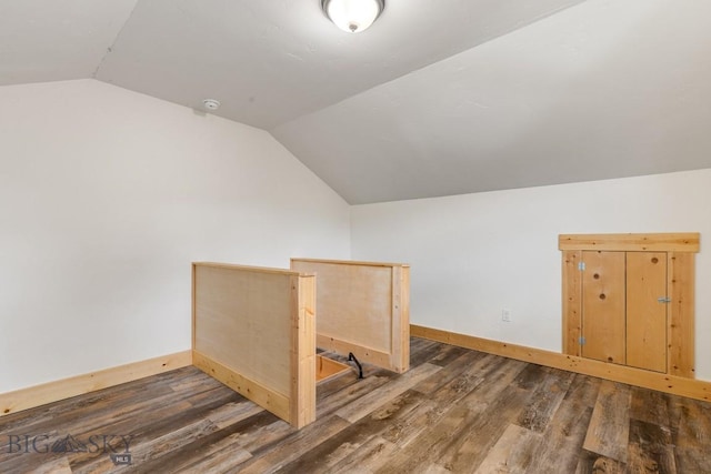 bonus room featuring lofted ceiling, baseboards, and wood finished floors