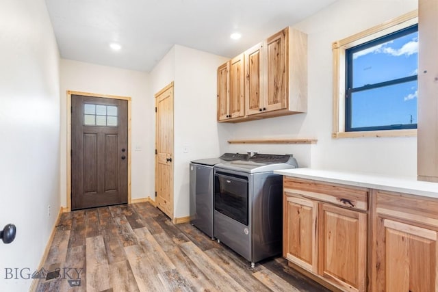washroom featuring washing machine and clothes dryer, cabinet space, dark wood-style floors, baseboards, and recessed lighting