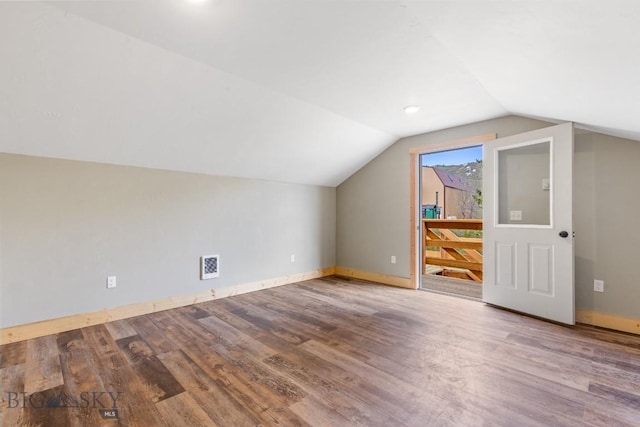 bonus room featuring wood finished floors, lofted ceiling, and baseboards