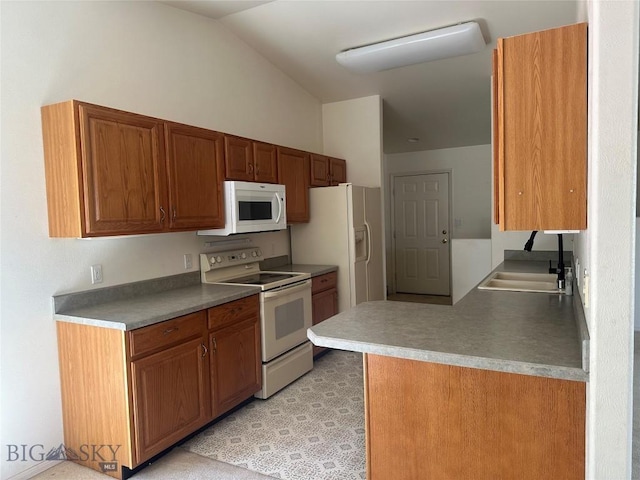 2921 Mammoth, Butte, MT 59701 - kitchen with white appliances, a sink, vaulted ceiling, brown cabinets, and a peninsula