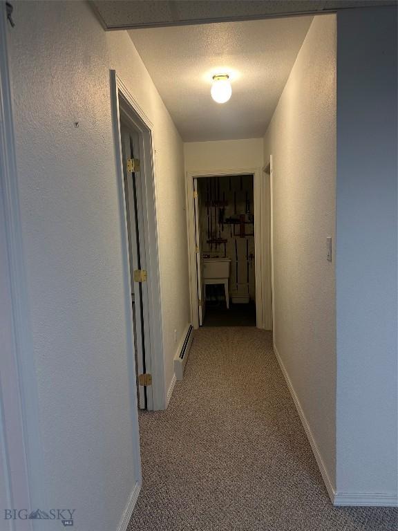 2921 Mammoth, Butte, MT 59701 - hallway featuring a baseboard radiator, carpet, a textured wall, and baseboards