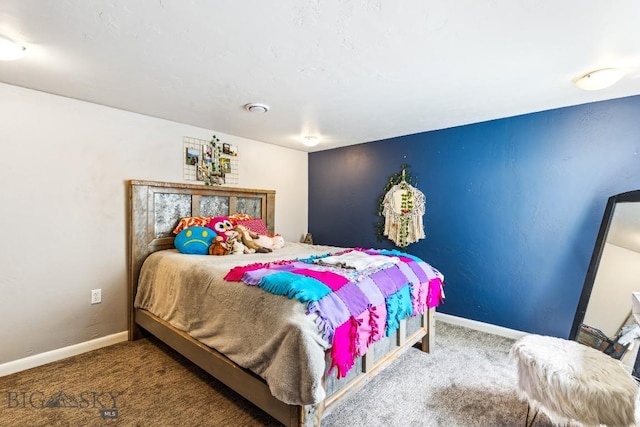 carpeted bedroom featuring baseboards