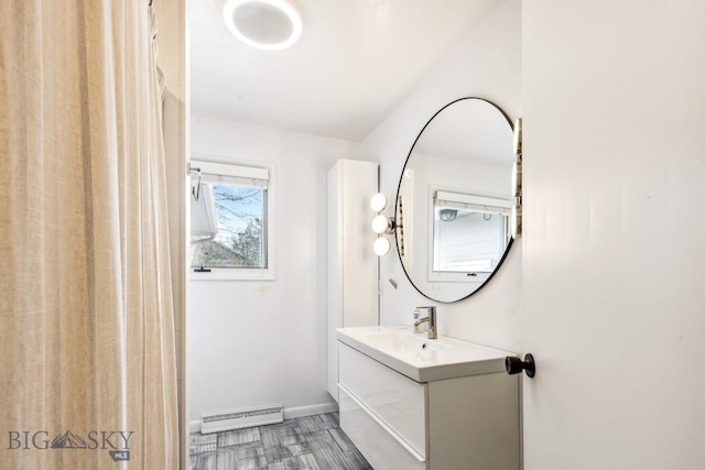 bathroom with vanity, baseboards, and a baseboard heating unit