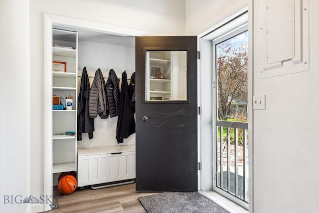 mudroom featuring radiator, wood finished floors, and electric panel