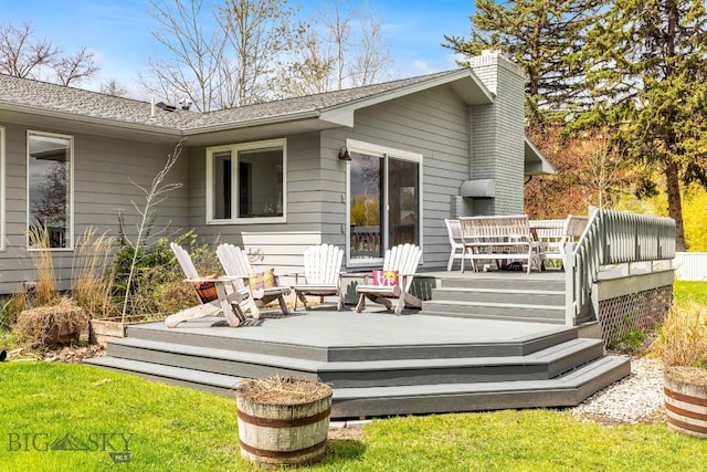 back of property featuring a wooden deck and a chimney