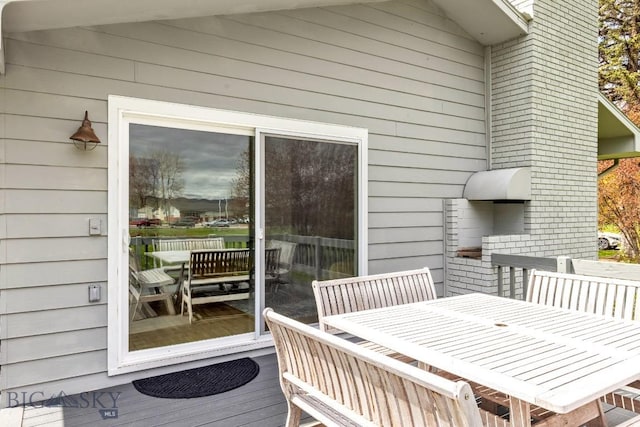 wooden terrace featuring outdoor dining area