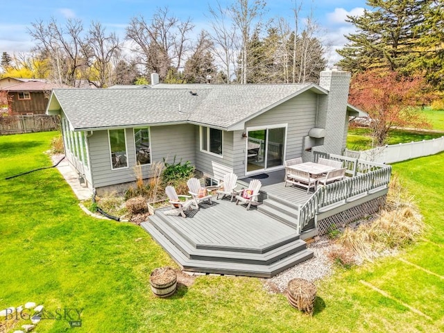 rear view of property with a chimney, roof with shingles, and a deck