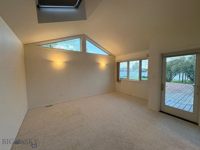 spare room featuring lofted ceiling and carpet