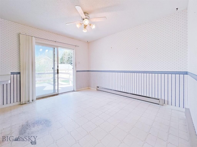 spare room featuring wallpapered walls, baseboard heating, tile patterned floors, ceiling fan, and a textured ceiling